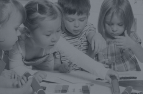 Niños pequeños jugando y aprendiendo en grupo en un aula infantil